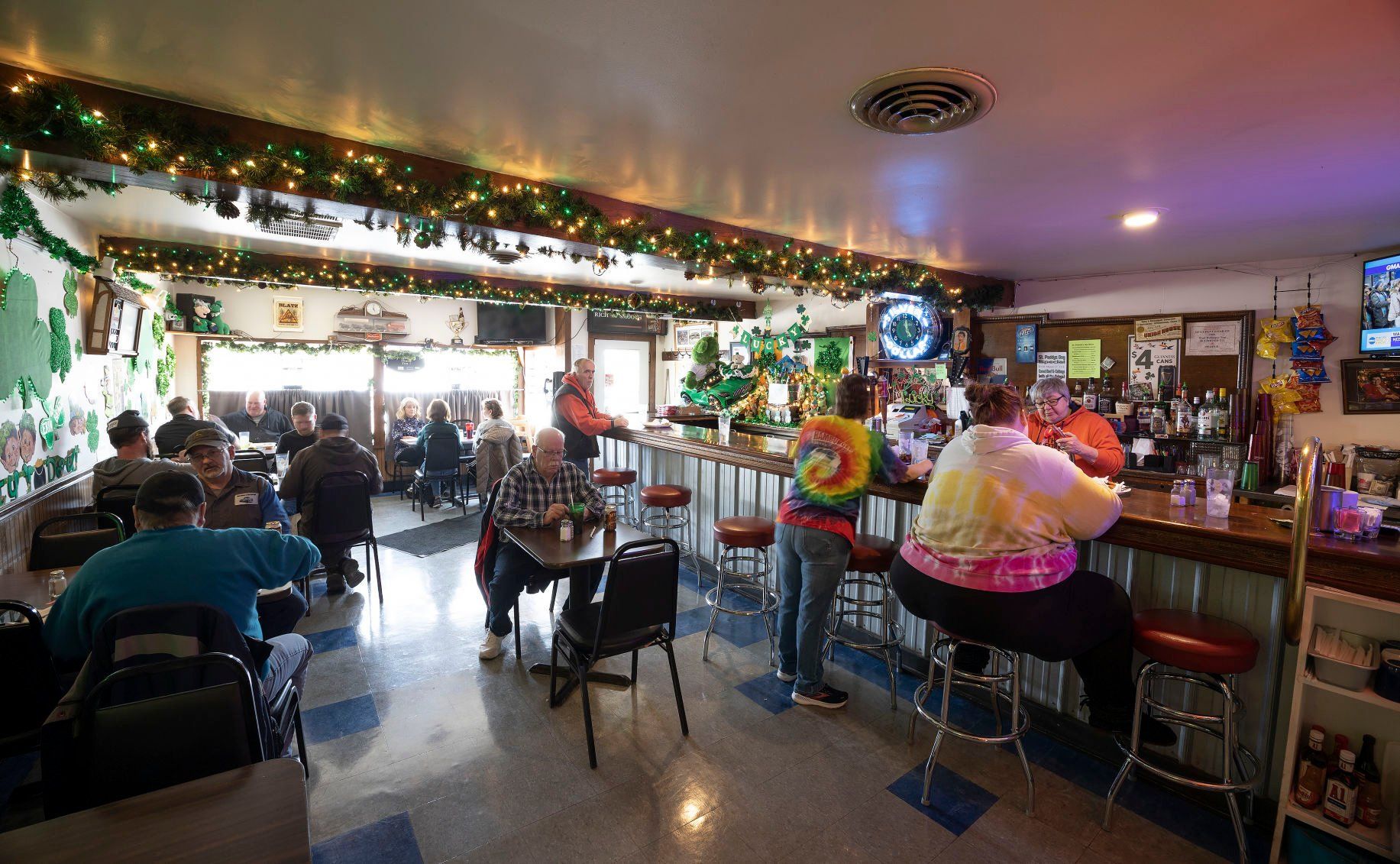 The lunch crowd arrives at West Dubuque Tap on Monday. Owner Kathy Ginter says she hasn’t seen some regulars for two years since COVID-19 hit.    PHOTO CREDIT: Stephen Gassman