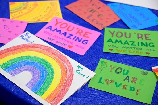 Disney cast members write messages on cards to be given to children dealing with LGBTQ issues, while participating in an employee walkout of Walt Disney World, Tuesday, March 22, 2022, in Orlando, Fla. (AP Photo/Phelan M. Ebenhack)    PHOTO CREDIT: Phelan M. Ebenhack