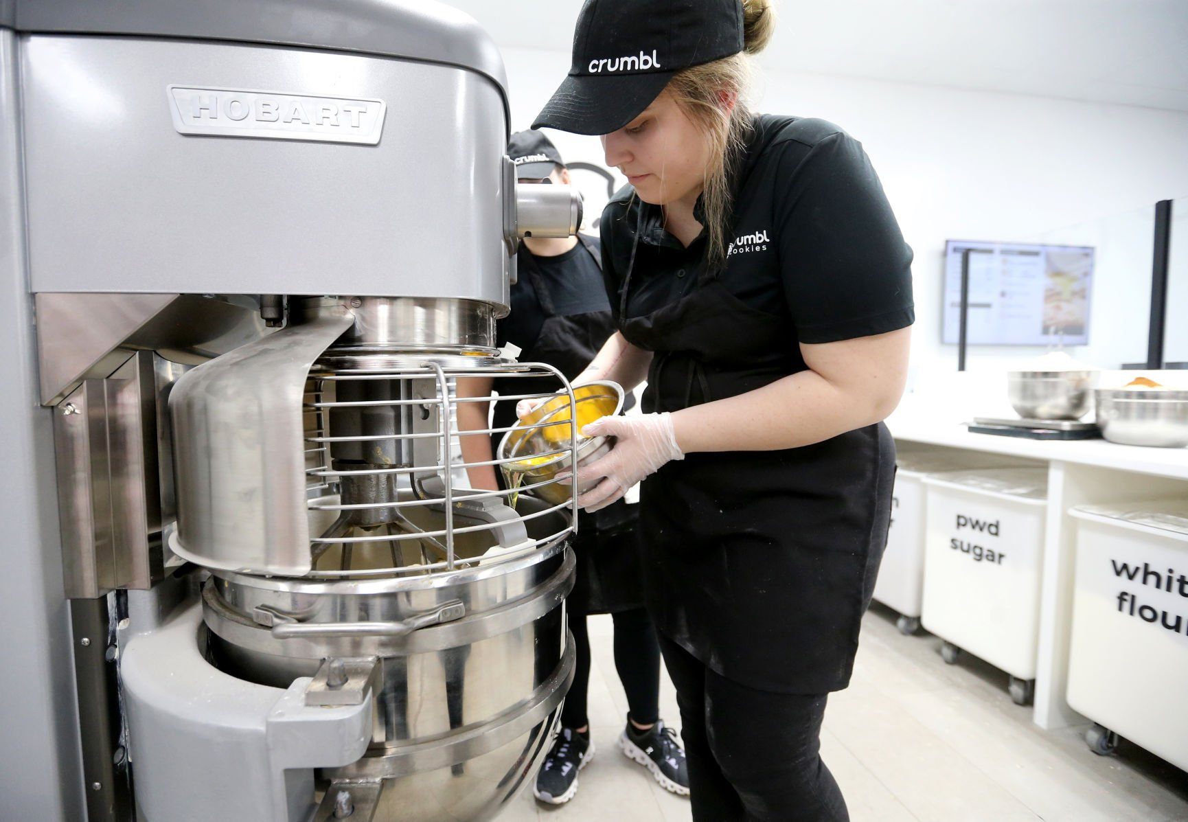 Hayley Francois makes a batch of oatmeal cookies at Crumbl Cookies in Dubuque on Wednesday, March 23, 2022. The store opens Friday, March 25.    PHOTO CREDIT: JESSICA REILLY