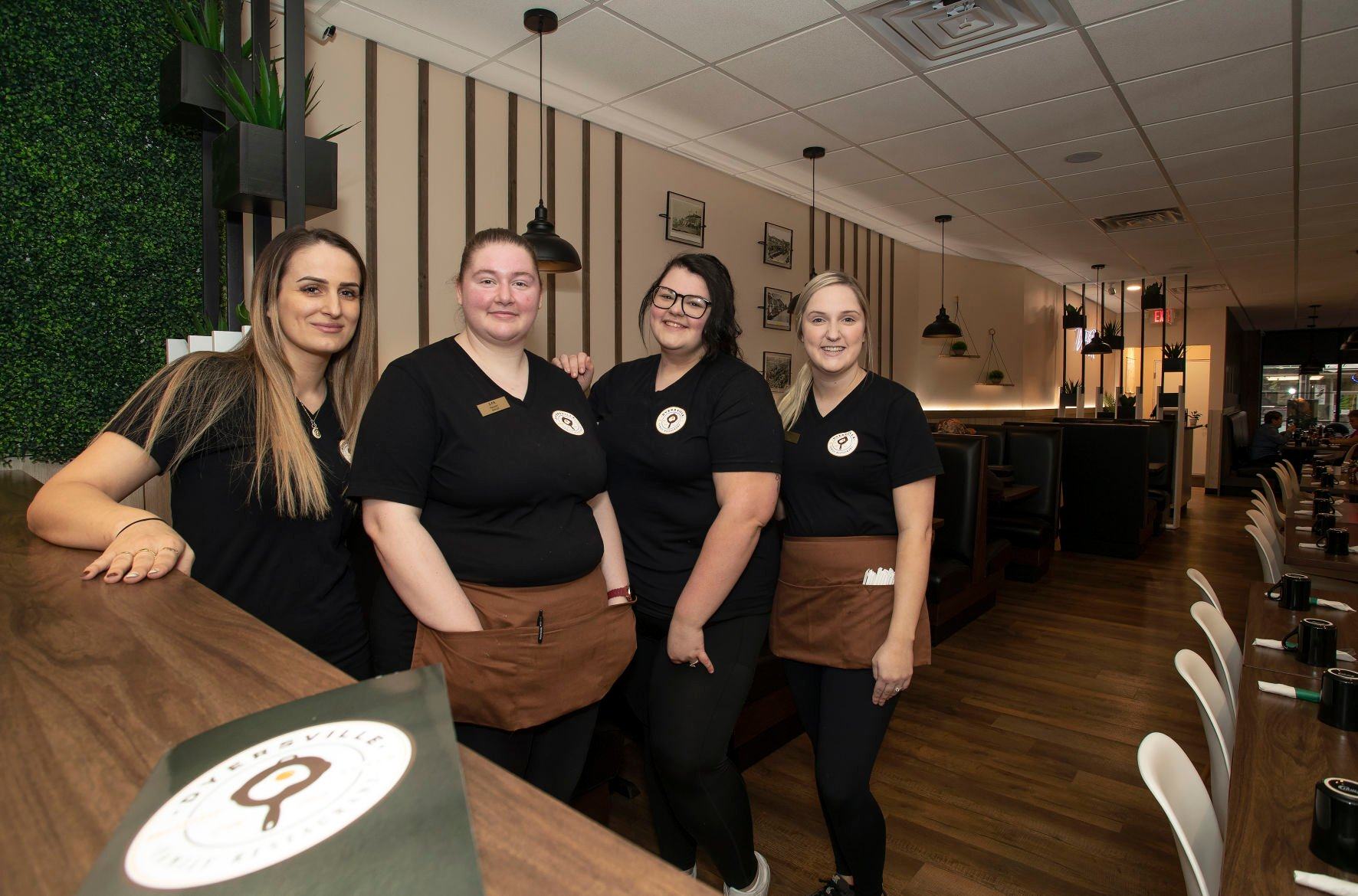Dyersville Family Restaurant owner Abby Sejdini (from left) and servers Kayleen Ellerbach, Brittany Jasper and Rylee Davis in the newly renovated business in Dyersville, Iowa, on Wednesday, March 23, 2022.    PHOTO CREDIT: Stephen Gassman