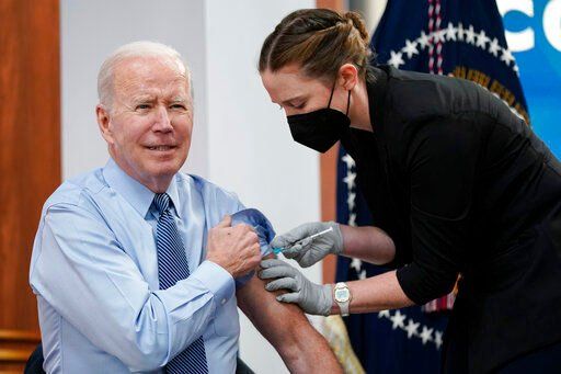 President Joe Biden receives his second COVID-19 booster shot in the South Court Auditorium on the White House campus, Wednesday, March 30, 2022, in Washington. (AP Photo/Patrick Semansky)    PHOTO CREDIT: Patrick Semansky