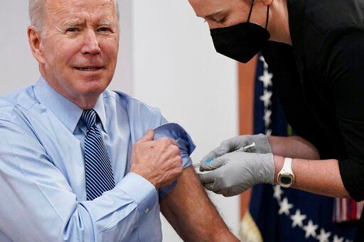 President Joe Biden receives a second COVID-19 booster shot Wednesday in the South Court Auditorium on the White House campus in Washington.    PHOTO CREDIT: Patrick Semansky