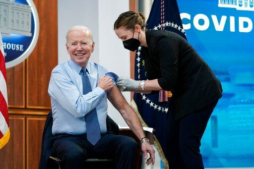 President Joe Biden reacts after receiving his second COVID-19 booster shot in the South Court Auditorium on the White House campus, Wednesday, March 30, 2022, in Washington. (AP Photo/Patrick Semansky)    PHOTO CREDIT: Patrick Semansky
