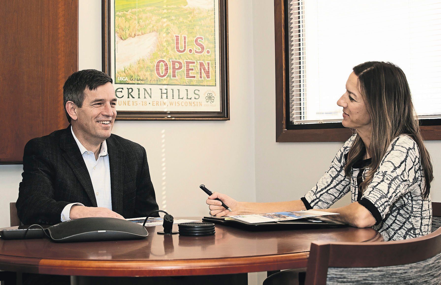 Eric Foy talks with Stacey Hines at the Central Avenue location of Dubuque Bank & Trust.    PHOTO CREDIT: Stephen Gassman