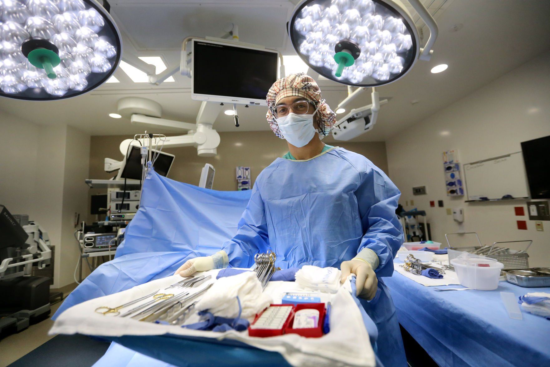 Jerry-Jordan Kane, a surgical technician at MercyOne Dubuque Medical Center, stands in an operating room at the hospital in Dubuque on Friday. He is the first graduate of a new training program at MercyOne.    PHOTO CREDIT: JESSICA REILLY