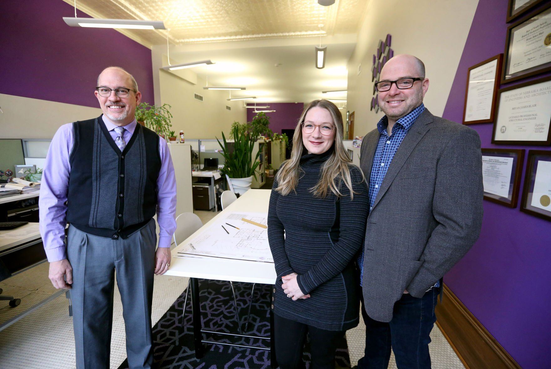 Kevin Eipperle (from left), president of FEH Design, and Emily and Andrew McCready, owners at 563 Design, stand at FEH Design in Dubuque on Monday, April 4, 2022. The McCreadys have joined FEH Design and have taken on new roles with the company.    PHOTO CREDIT: JESSICA REILLY
