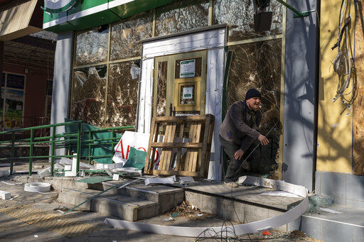 A man exits a damaged pharmacy following a bombing, last day, that killed nine civilians, in Mykolaiv Ukraine, Tuesday, April 5, 2022. (AP Photo/Petros Giannakouris)    PHOTO CREDIT: Petros Giannakouris