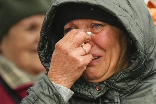 A woman cries as she waits in a line after fleeing the war from neighbouring Ukraine at the border crossing in Medyka, southeastern Poland, Tuesday, April 5, 2022. Ukraine’s president plans to address the U.N.’s most powerful body after even more grisly evidence emerged of civilian massacres in areas that Russian forces recently left. (AP Photo/Sergei Grits)    PHOTO CREDIT: Sergei Grits