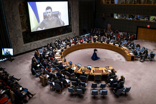 Ukrainian President Volodymyr Zelenskyy speaks via remote feed during a meeting of the UN Security Council, Tuesday, April 5, 2022, at United Nations headquarters. Zelenskyy will address the U.N. Security Council for the first time Tuesday at a meeting that is certain to focus on what appear to be widespread deliberate killings of civilians by Russian troops. (AP Photo/John Minchillo)    PHOTO CREDIT: John Minchillo