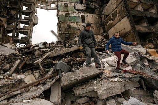 A resident looks for belongings in the ruins of an apartment building destroyed during fighting between Ukrainian and Russian forces in Borodyanka, Ukraine, Tuesday, April 5, 2022. Ukrainian President Volodymyr Zelenskyy accused Russian troops of gruesome atrocities in Ukraine and told the U.N. Security Council on Tuesday that those responsible should immediately be brought up on war crimes charges in front of a tribunal like the one set up at Nuremberg after World War II.(AP Photo/Vadim Ghirda)    PHOTO CREDIT: Vadim Ghirda
