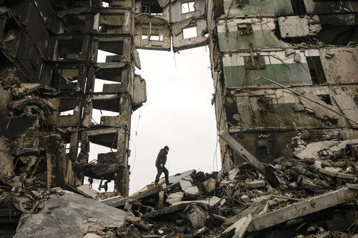A resident looks for belongings in an apartment building destroyed during fighting between Ukrainian and Russian forces in Borodyanka, Ukraine, Tuesday, April 5, 2022. Ukrainian President Volodymyr Zelenskyy accused Russian troops of gruesome atrocities in Ukraine and told the U.N. Security Council on Tuesday that those responsible should immediately be brought up on war crimes charges in front of a tribunal like the one set up at Nuremberg after World War II.(AP Photo/Vadim Ghirda)    PHOTO CREDIT: Vadim Ghirda
