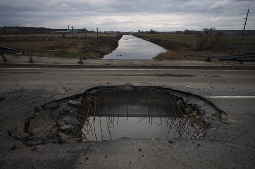 The Irpin river is seen through a damaged bridge in Bucha, on the outskirts of Kyiv, Ukraine, Wednesday, April 6, 2022. (AP Photo/Felipe Dana)    PHOTO CREDIT: Felipe Dana