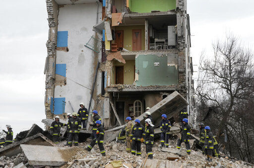 Emergency workers search through the rubble of an apartment building following a Russian attack in Borodyanka, Ukraine, Wednesday, Apr. 6, 2022. Ukrainian authorities are poring over the grisly aftermath of alleged Russian atrocities around Kyiv, as both sides prepare for an all-out push by Moscow