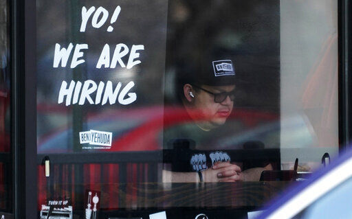 A hiring sign is displayed at a restaurant in Schaumburg, Ill., Friday, April 1, 2022. Fewer Americans applied for unemployment benefits last week as layoffs remain at historically low levels. Jobless claims fell by 5,000 to 166,000 for the week ending April 2, the Labor Department reported Thursday. (AP Photo/Nam Y. Huh)    PHOTO CREDIT: Nam Y. Huh
