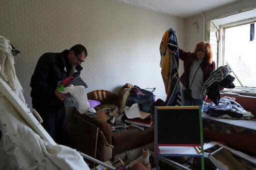 Serhiy, left, and Liumila collect unbroken belongings at their children