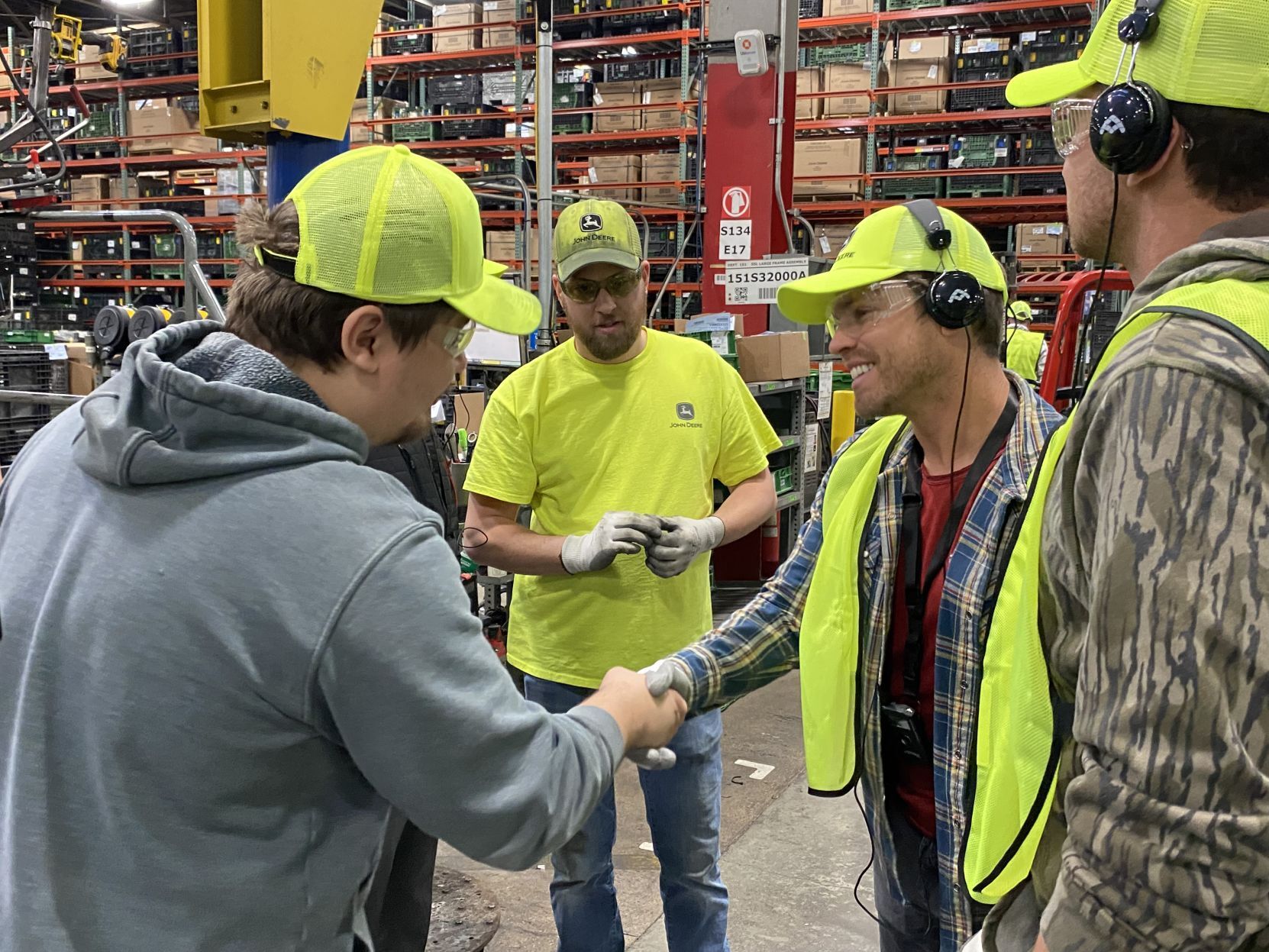 Country music star Dustin Lynch shakes hands with a John Deere Dubuque Works employee during a tour of the plant Thursday.     PHOTO CREDIT: Contributed
