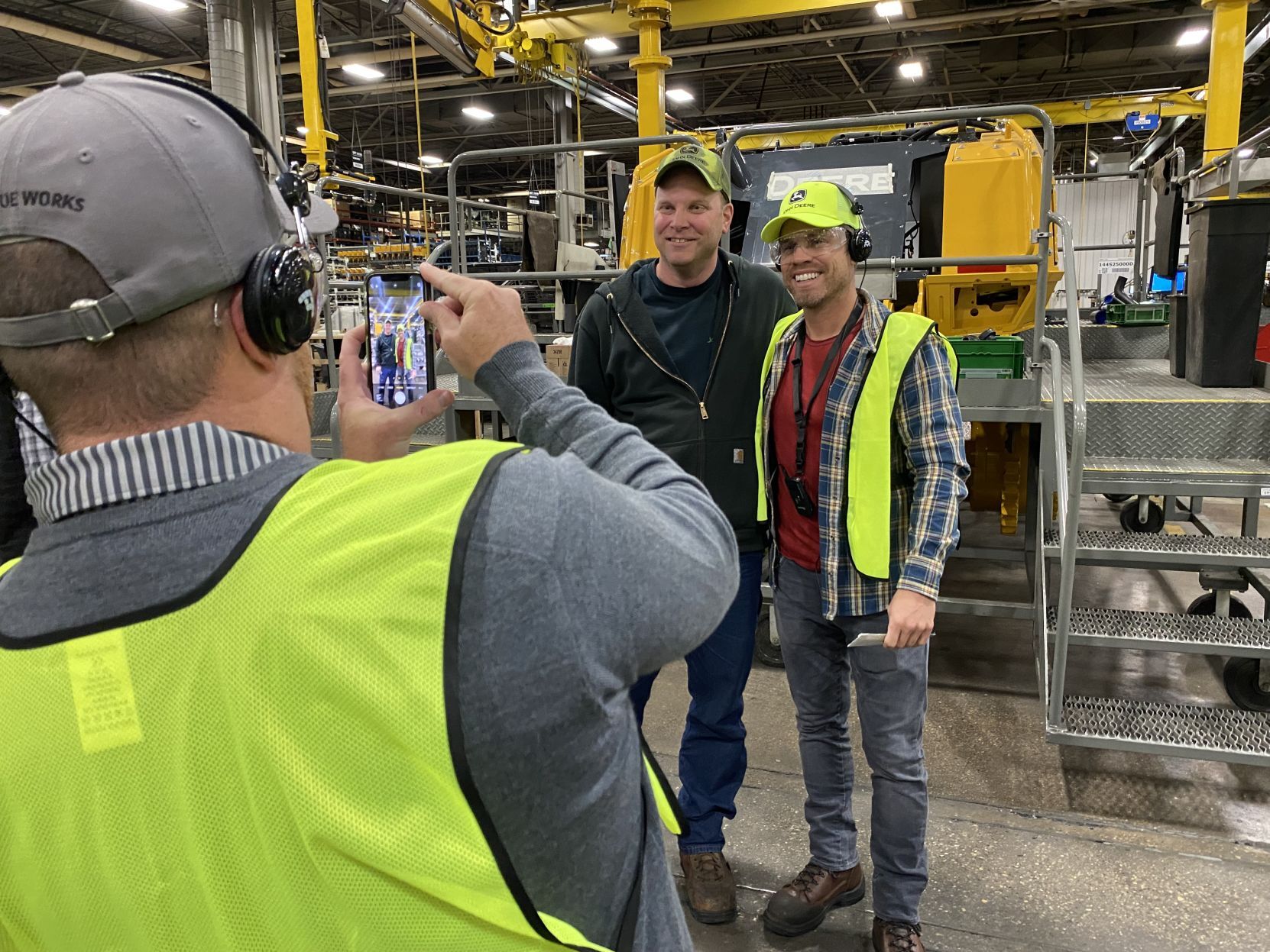 Country music star Dustin Lynch (right) poses for a photo at John Deere Dubuque Works on Thursday.     PHOTO CREDIT: Contributed