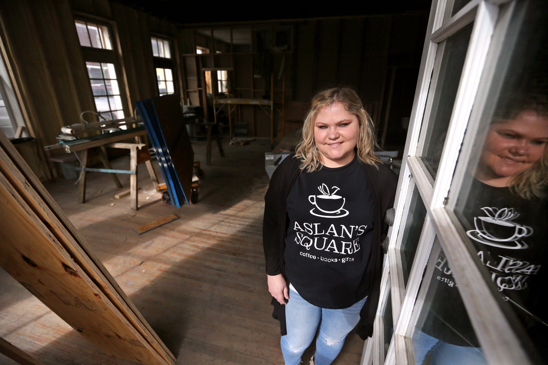 Owner Jacey Stanbro stands at Aslan’s Square in Dyersville, Iowa, on Wednesday. The new business will feature a bookstore, coffee shop and gift store, and it is expected to open this summer.    PHOTO CREDIT: JESSICA REILLY