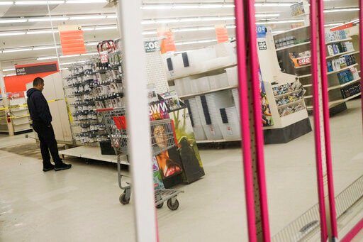 People shop the half-empty shelves of the Kmart in Avenel, N.J., Monday, April 4, 2022. When the Kmart in Avenel closes its doors on April 16, it will leave only three remaining U.S. locations for the former retail powerhouse. It