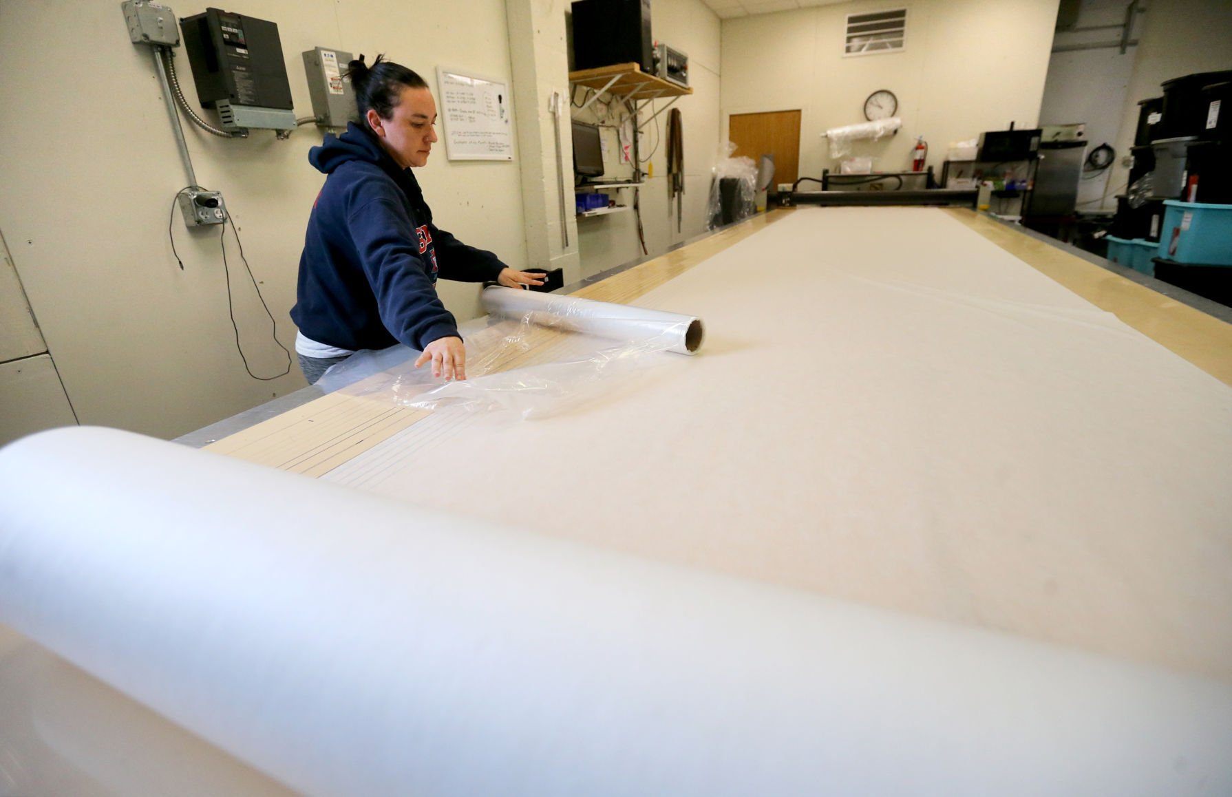 Amber Herber rolls out material to cut at Bauer RV Upholstery in Dickeyville, Wis., on Monday, April 11, 2022.    PHOTO CREDIT: JESSICA REILLY