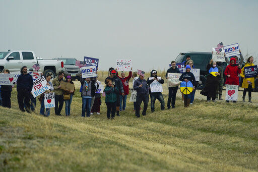 Supporters hold signs as President Joe Biden arrives at POET Bioprocessing in Menlo, Iowa, Tuesday, April 12, 2022. (AP Photo/Carolyn Kaster)    PHOTO CREDIT: Carolyn Kaster