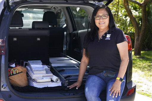 Natalia Ponce De Leon, owner of Custom Window Furnishings, sits on the back of her nine-year-old Toyota RAV4 after visiting with a client. Ponce De Leon traded her 2018 Toyota Tacoma for a more efficient car where she estimates will save her hundreds of dollars a month. She is also able to carry all the tools she needs for her business.     PHOTO CREDIT: Marta Lavandier