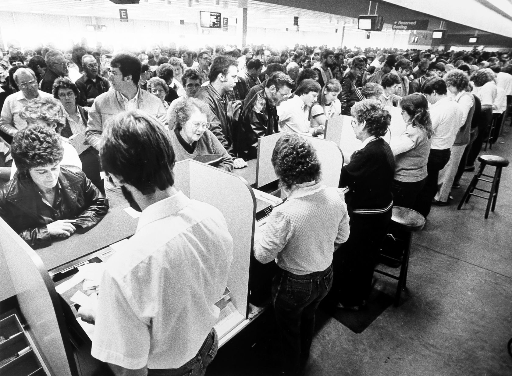 People place their bets at Dubuque Greyhound Park in 1985.    PHOTO CREDIT: Telegraph Herald file