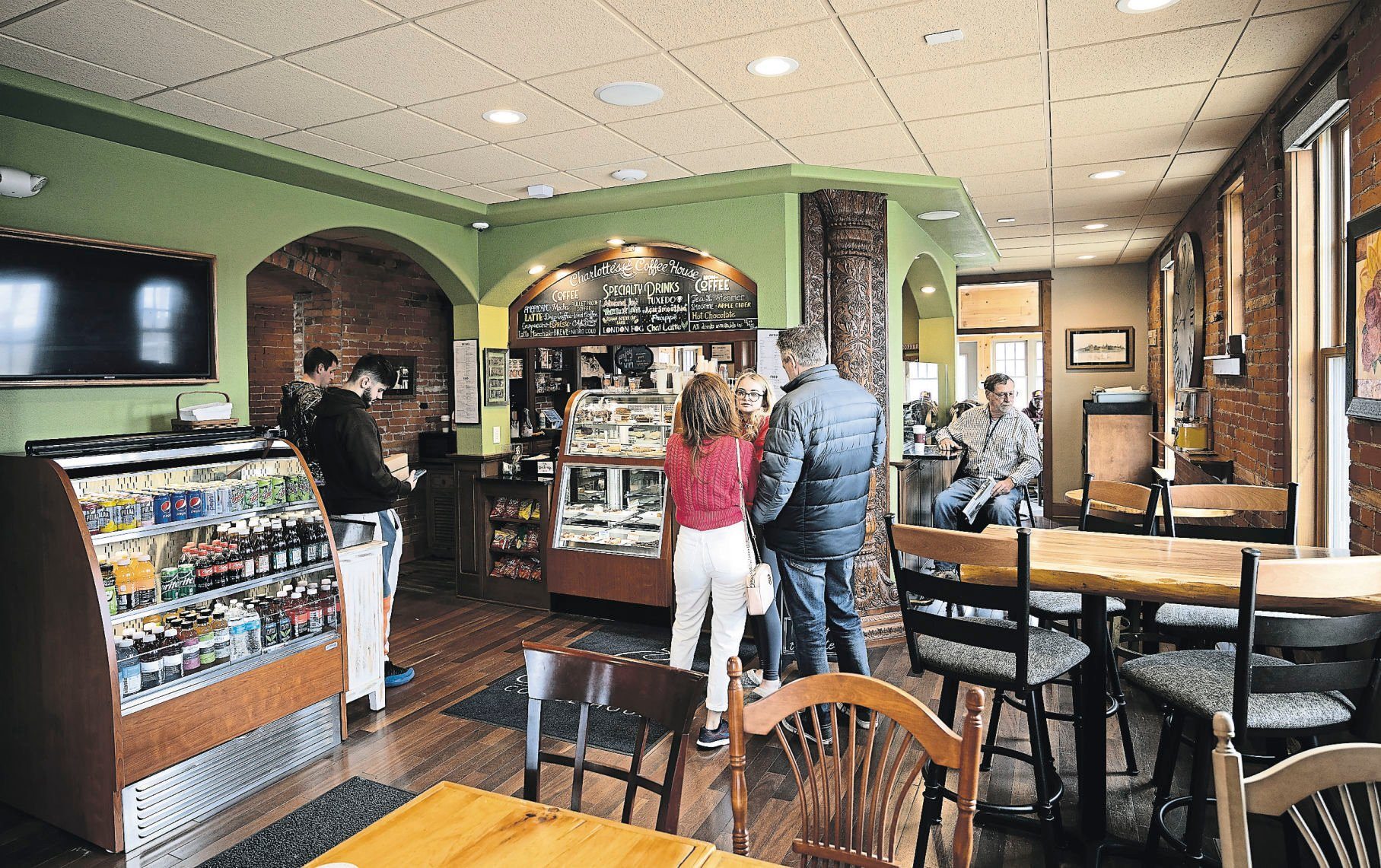 Customers wait on orders at Charlotte’s Coffee House in Dubuque on Saturday, April 16, 2022.    PHOTO CREDIT: Stephen Gassman