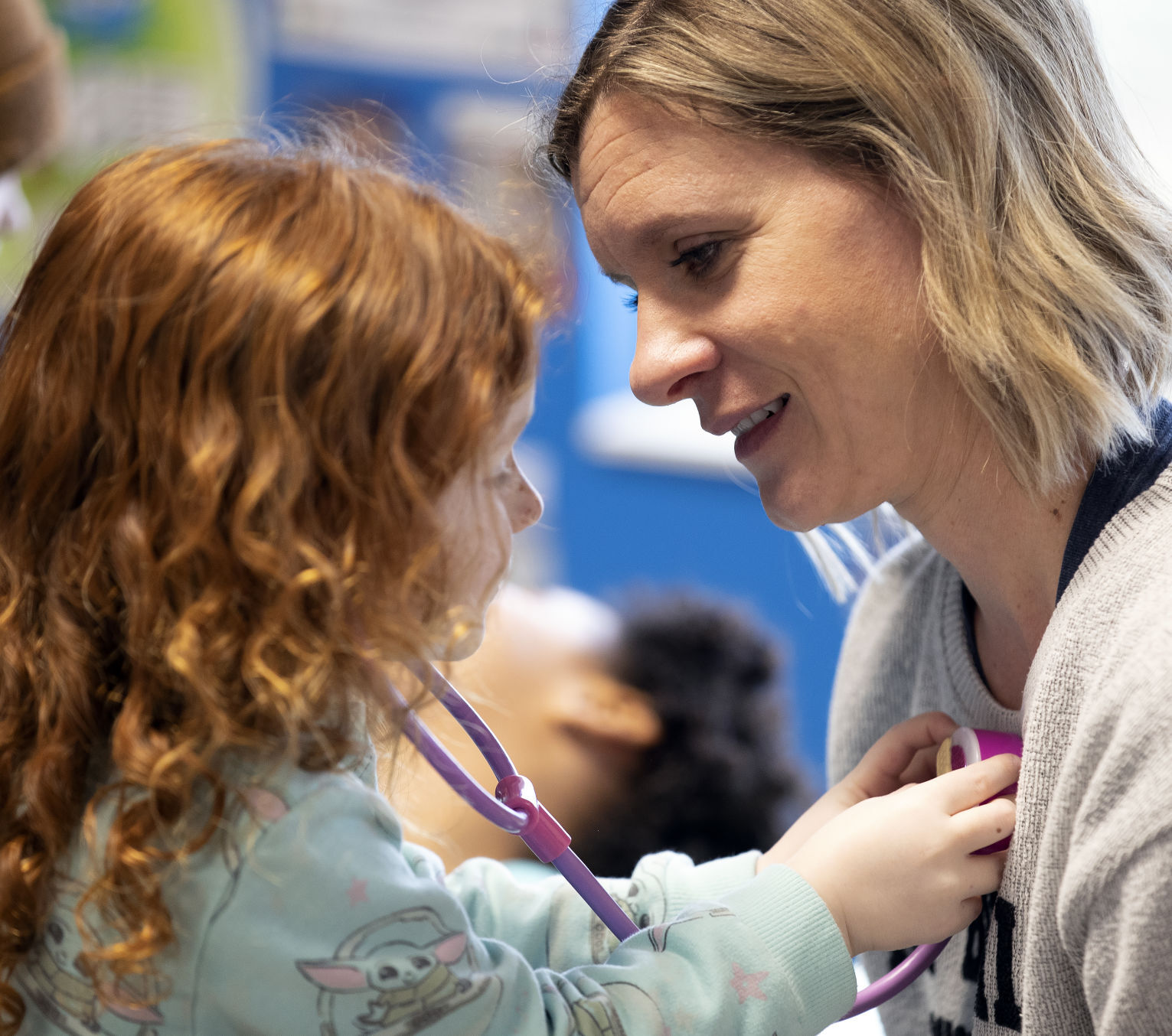 Sierra Piersch, 3, listens to the heart of Young-Uns teacher Nicole Thill at Young-Uns Child Care on Monday, April 18, 2022.    PHOTO CREDIT: Stephen Gassman