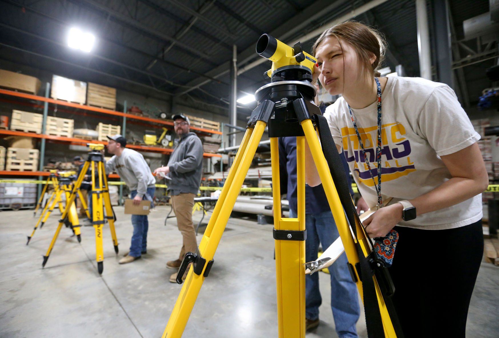 Alexis Stratton, a sophomore at Dubuque Senior High School, looks through a builder’s level during the Construction Industry Career Expo at Portzen Construction in Dubuque on Thursday.    PHOTO CREDIT: JESSICA REILLY