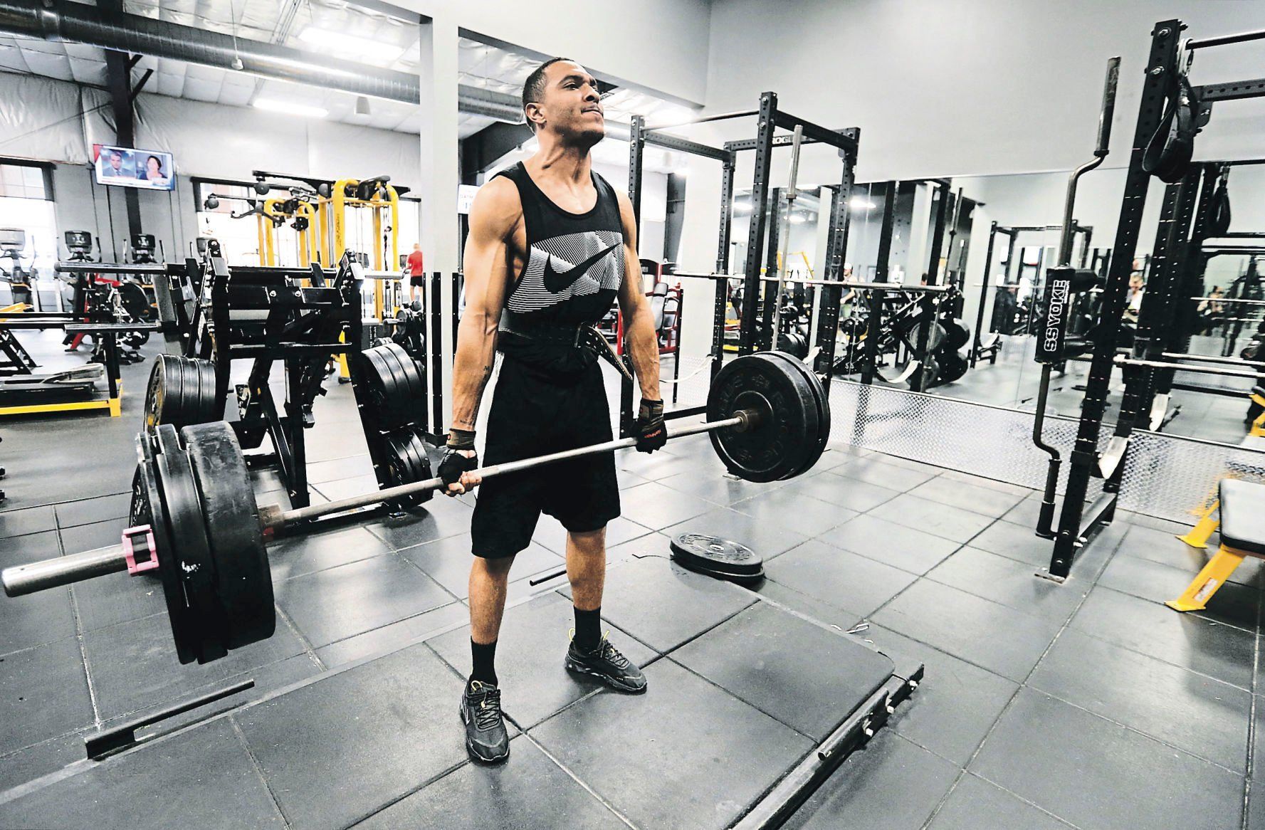 Brandon Winfrey, of Dubuque, lifts weights at Volv Fitness.    PHOTO CREDIT: JESSICA REILLY