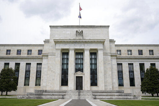 FILE - This May 4, 2021, file photo shows the Federal Reserve building in Washington. The Federal Reserve is poised this week to begin unleashing its most drastic steps in three decades to attack inflation by making it costlier to borrow — for a car, a home, a business deal, a credit card purchase — all of which will compound Americans