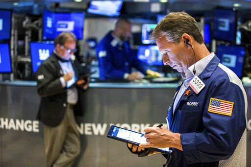 In this photo provided by the New York Stock Exchange, trader Robert Charmak, right, works on the floor, Monday May 2, 2022. The subdued start to May follows a dismal April, where Big Tech companies dragged the broader market lower as they started to look overpriced, particularly with interest rates set to rise sharply. (Courtney Crow/New York Stock Exchange via AP)    PHOTO CREDIT: Courtney Crow