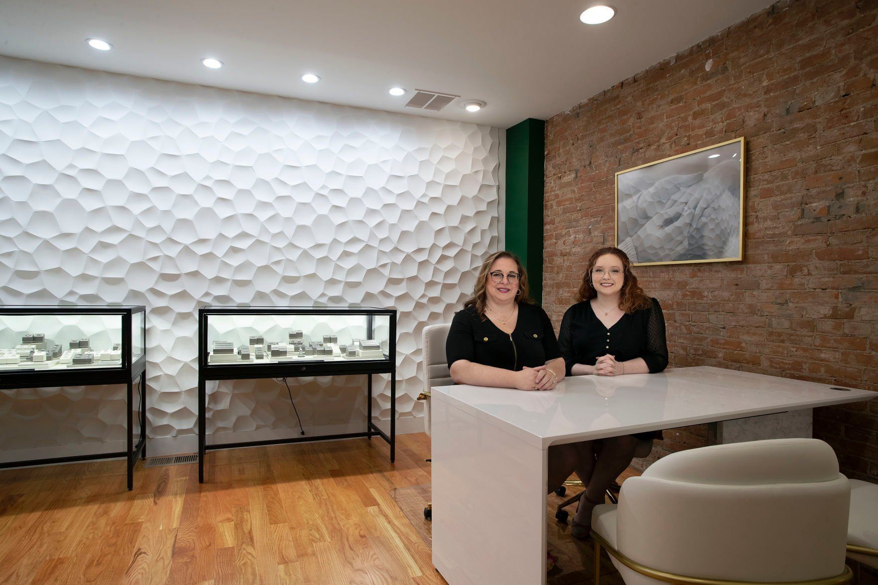 McCoy Goldsmith & Jeweler co-owner Jennifer McCoy (left) and Store Manager Samantha Swift sit in the new addition to the longtime Main Street location in Dubuque on Thursday, May 5, 2022.    PHOTO CREDIT: Stephen Gassman
