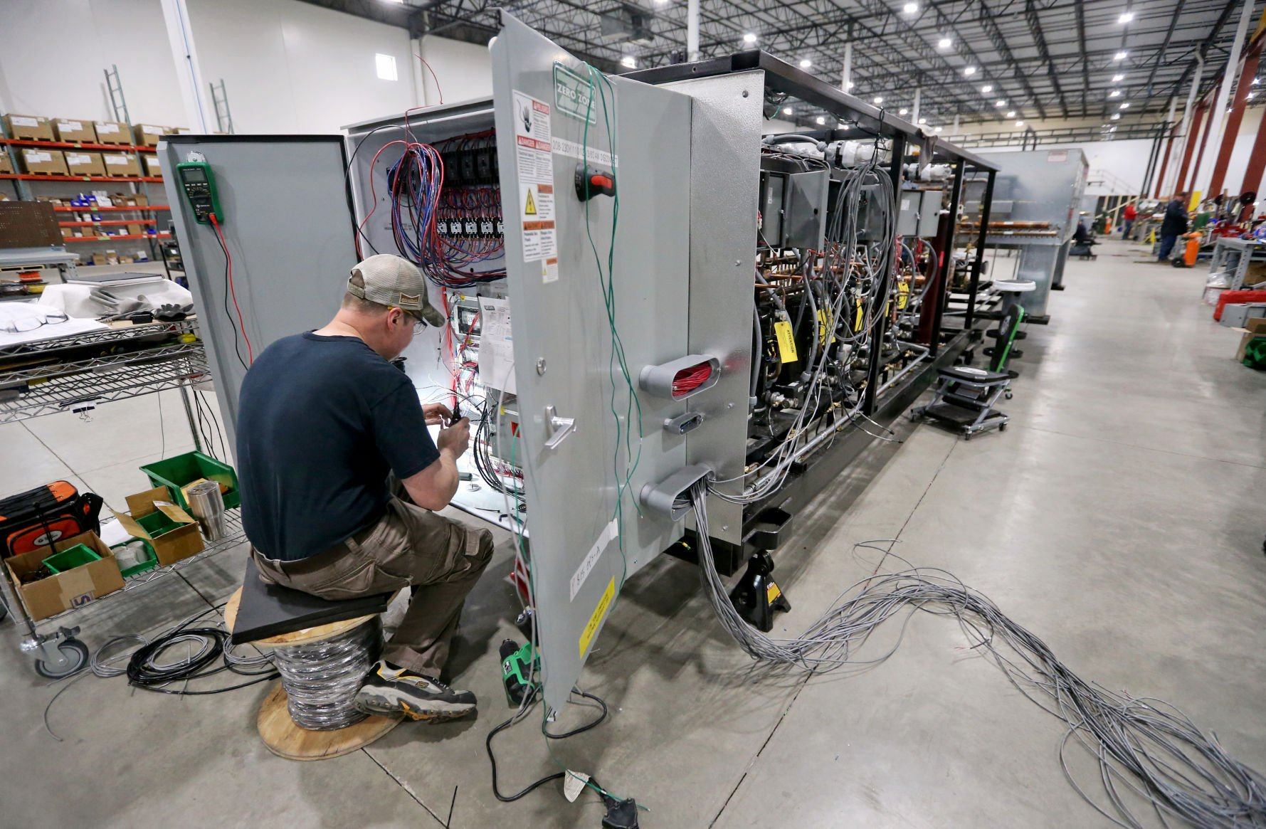 Bob Naeve works to install electrical wiring on an industrial refrigeration unit at Zero Zone in Dyersville, Iowa, on Thursday, May 5, 2022.    PHOTO CREDIT: JESSICA REILLY