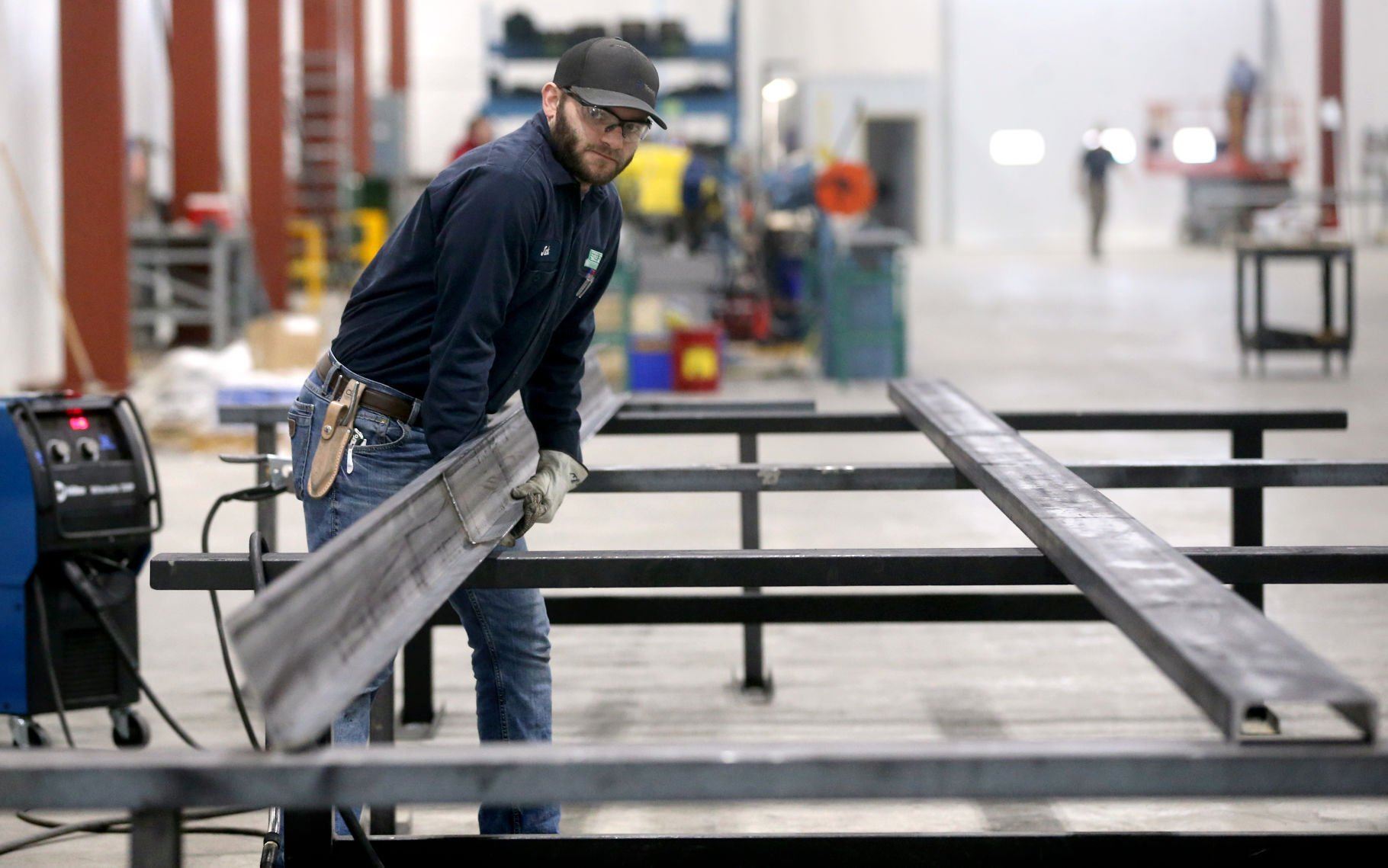 Jack Funke moves a beam at Zero Zone in Dyersville, Iowa, on Thursday.    PHOTO CREDIT: JESSICA REILLY