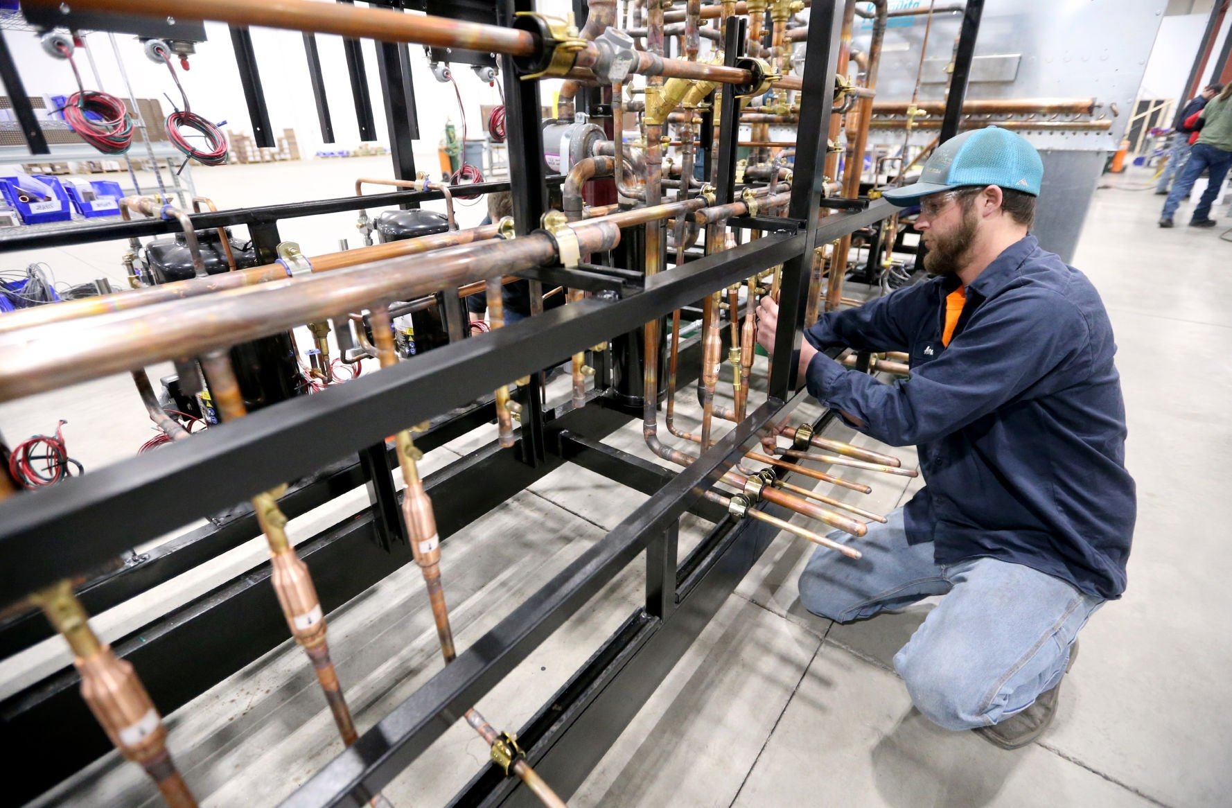 Andrew Bacon works on a pipe for an industrial refrigeration unit at Zero Zone in Dyersville, Iowa, on Thursday, May 5, 2022.    PHOTO CREDIT: JESSICA REILLY