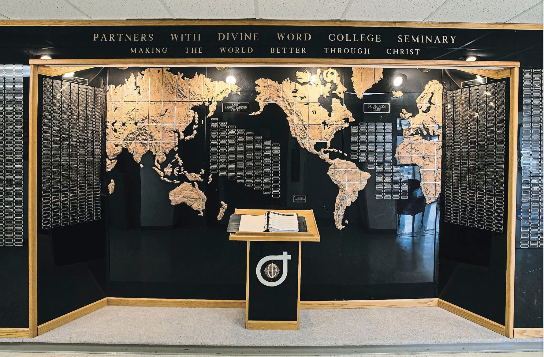 The “Partners With Divine Word College Seminary” wall at Divine Word College in Epworth, Iowa.    PHOTO CREDIT: Stephen Gassman