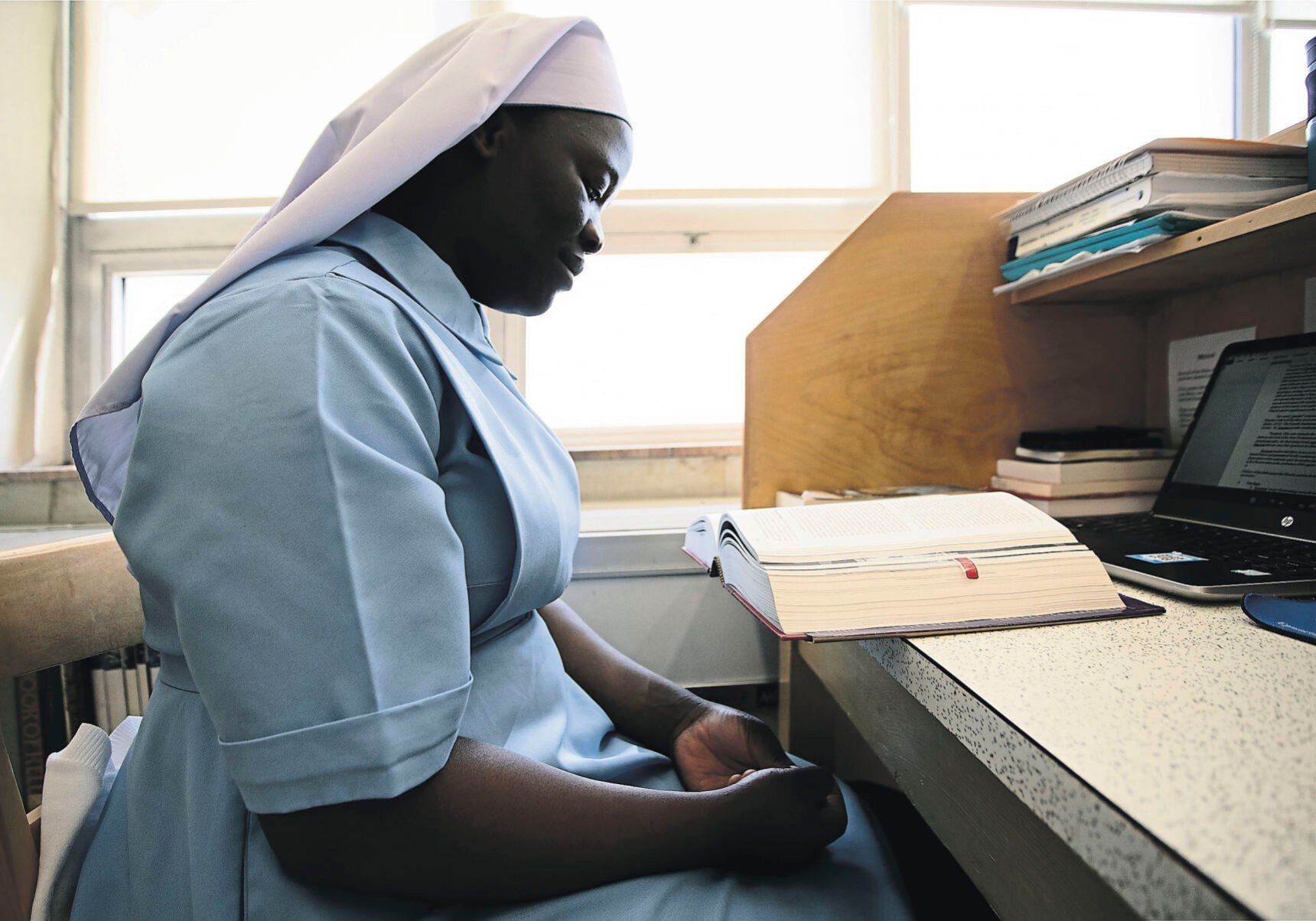 Sister Scovia Okello Apiyo, of Uganda, studies in the library.    PHOTO CREDIT: Stephen Gassman
