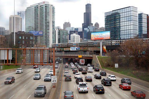 Traffic flows along Interstate 90 highway as a Metra suburban commuter train moves along an elevated track in Chicago. Upcoming data shows traffic deaths soaring in the U.S. The Biden administration is steering $5 billion in federal aid to cities and localities to address the growing crisis.    PHOTO CREDIT: Shafkat Anowar