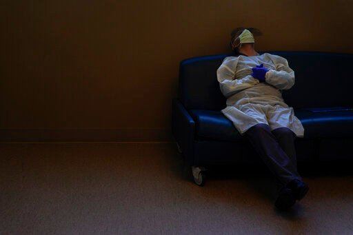 FILE - Dr. Mher Onanyan takes a short break while waiting for an X-ray of a COVID-19 patient