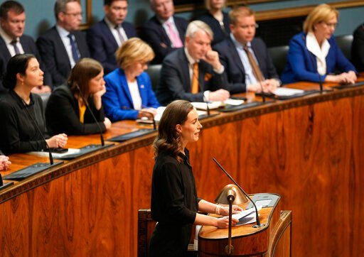 Prime Minister of Finland Sanna Marin talks in front of government members at the Finnish Parliament in Helsinki, Finland, Monday, May 16, 2022. Finland