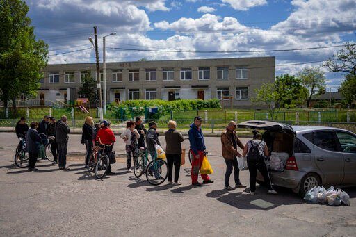 Residents queue to receive food donations in Kharkiv, Ukraine, Monday, May 16, 2022. (AP Photo/Bernat Armangue)    PHOTO CREDIT: Bernat Armangue