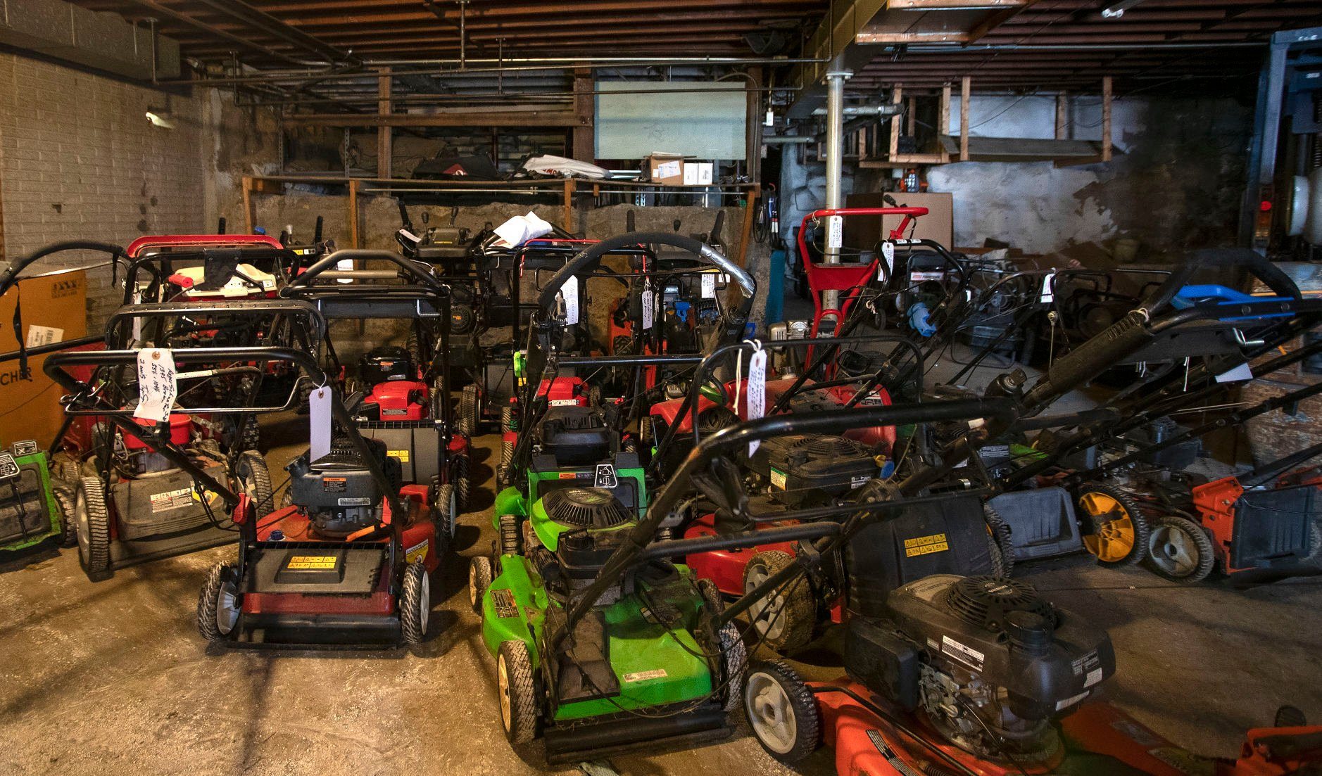 Mowers lined up in the repair shop at McGovern Hardware in Dubuque on Thursday, May 12, 2022.    PHOTO CREDIT: Stephen Gassman