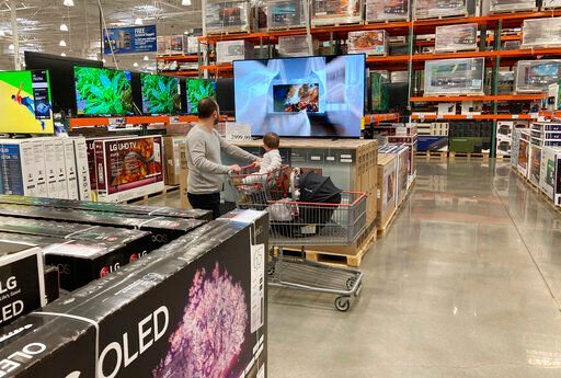 FILE - A shopper pushes a child in a cart while browsing big-screen televisions on display in the electronics section of a Costco warehouse, Tuesday, March 29, 2022, in Lone Tree, Colo. U.S. retail sales rose 0.9% in April, a solid increase that underscores Americans’ ability to keep ramping up spending even as inflation persists at nearly a 40-year high. The Commerce Department said Tuesday, May 17, that the increase was driven by greater sales of cars, electronics, and at restaurants. Even adjusting for inflation, which was 0.3% on a monthly basis in April, sales increased. (AP Photo/David Zalubowski, File)    PHOTO CREDIT: David Zalubowski