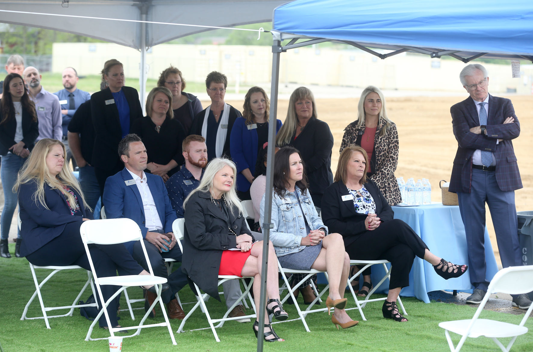 People attend a groundbreaking for Collins Community Credit Union