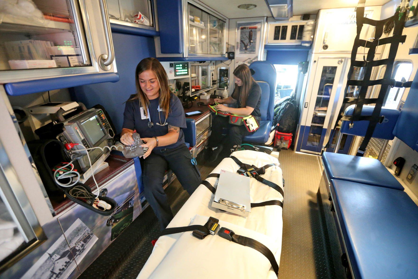Bailey Dragusica (left) and Karoline Stratton check supplies in an ambulance at Paramount Ambulance in Dubuque on Tuesday.    PHOTO CREDIT: JESSICA REILLY