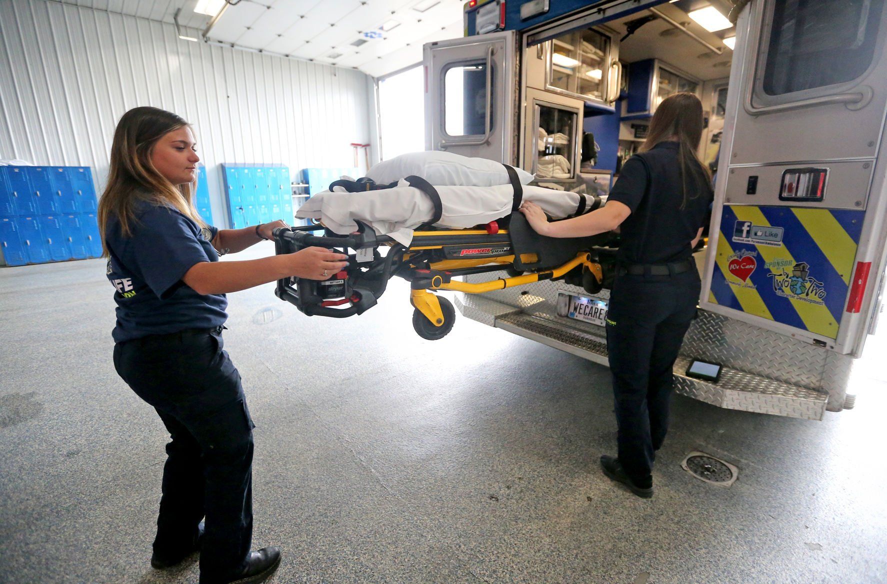 Bailey Dragusica (left) and Karoline Stratton check supplies in an ambulance at Paramount Ambulance in Dubuque on Tuesday, May 17, 2022.    PHOTO CREDIT: JESSICA REILLY