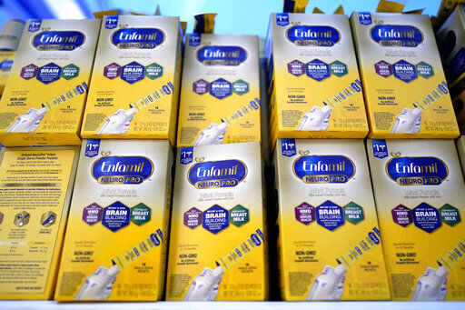 FILE - Infant formula is stacked on a table during a baby formula drive to help with the shortage May 14, 2022, in Houston. President Joe Biden has invoked the Defense Production Act to speed production of infant formula and has authorized flights to import supply from overseas. (AP Photo/David J. Phillip, File)    PHOTO CREDIT: David J. Phillip