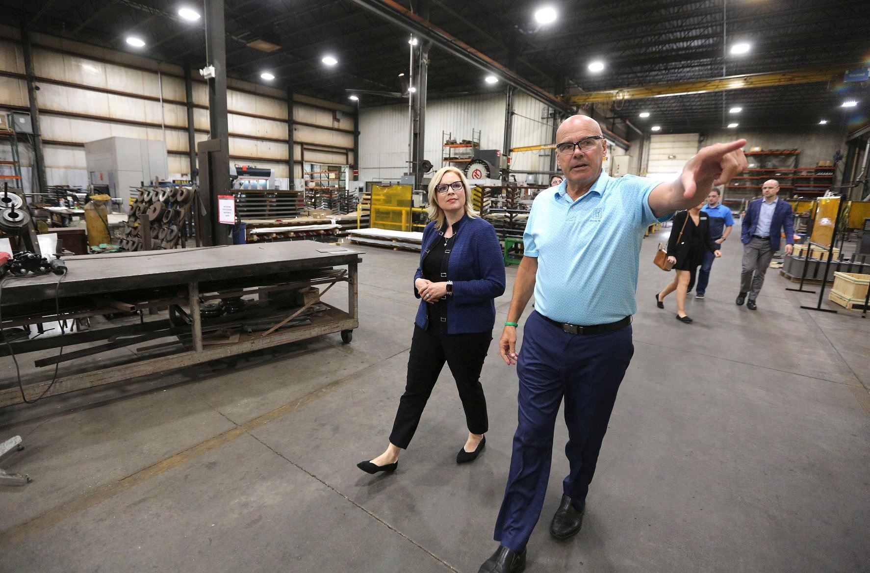 U.S. Rep. Ashley Hinson, R-Iowa, talks with Charlie Giese, president of Giese Companies in Dubuque, during a tour of the manufacturing facility on Monday. Giese said hiring workers is difficult and more could be done to promote the trades.    PHOTO CREDIT: Dave Kettering
